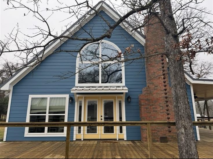Home exterior after repainting in a fresh blue-gray, full exterior house painting in the Brazos Valley, TX (College Station and Bryan)